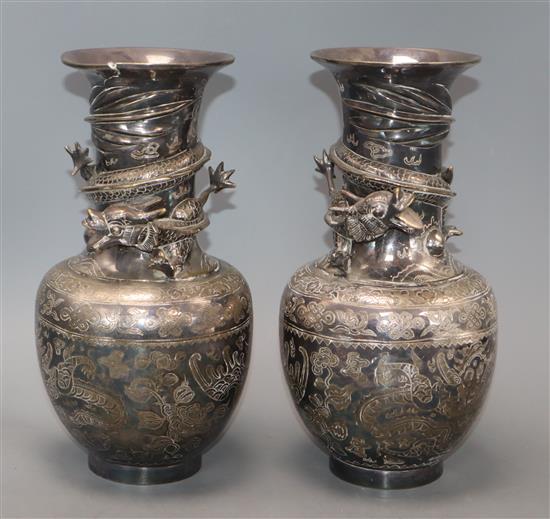 A pair of Japanese silver-plated bronze vases engraved and applied with dragons (one rim a.f.) height 25cm